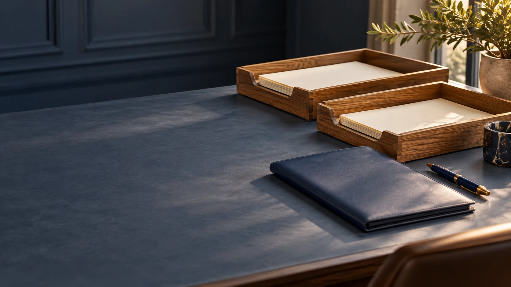 Two clearly separated document trays with a folder and pen on a quiet work surface.